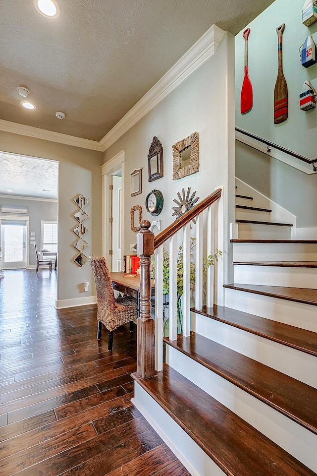 staircase featuring hardwood / wood-style floors and crown molding