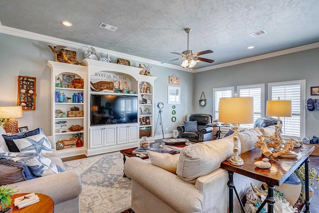 living room with light wood-type flooring, ornamental molding, and a textured ceiling