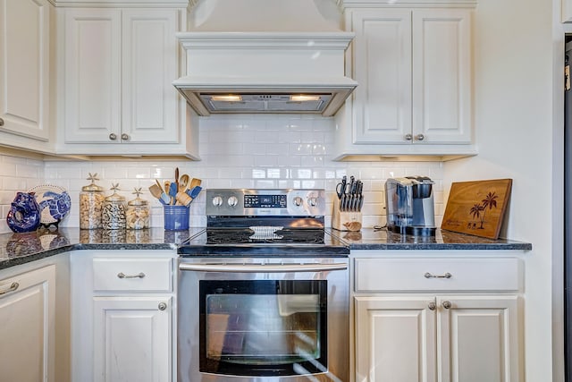 kitchen featuring white cabinets, decorative backsplash, premium range hood, and stainless steel range with electric cooktop