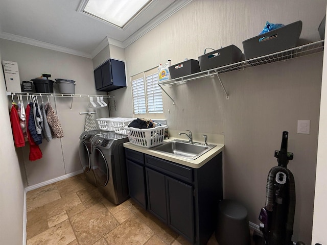 washroom with crown molding, sink, cabinets, and washer and dryer