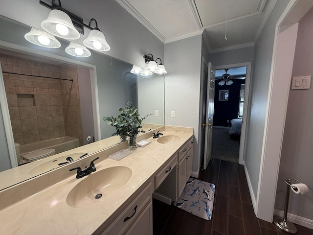 bathroom featuring vanity, tiled shower / bath combo, ceiling fan, and ornamental molding