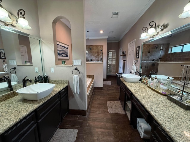 bathroom featuring vanity, separate shower and tub, and ornamental molding