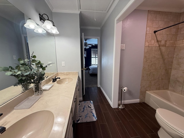 full bathroom with vanity, crown molding, tiled shower / bath, ceiling fan, and toilet