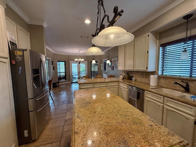 kitchen featuring sink, hanging light fixtures, kitchen peninsula, stainless steel appliances, and a chandelier