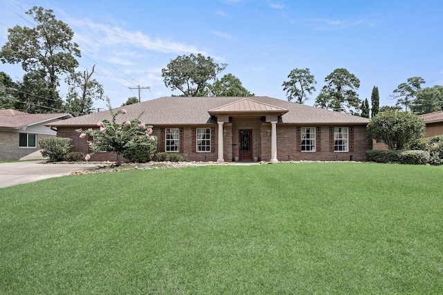 3590 Wheat Dr, Beaumont, TX 77706 - ranch-style home with brick siding, a front yard, and roof with shingles