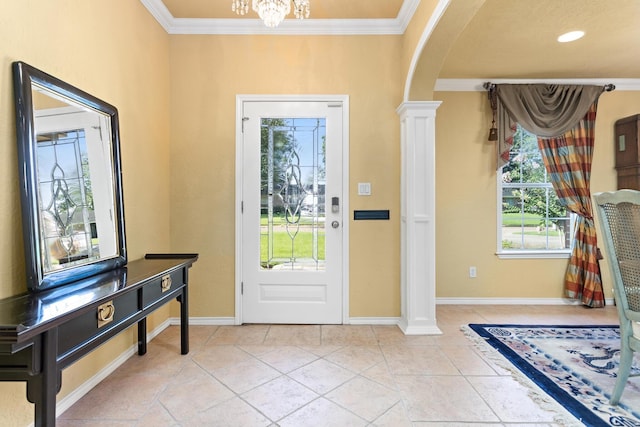 3590 Wheat Dr, Beaumont, TX 77706 - foyer entrance featuring arched walkways, decorative columns, ornamental molding, and a chandelier