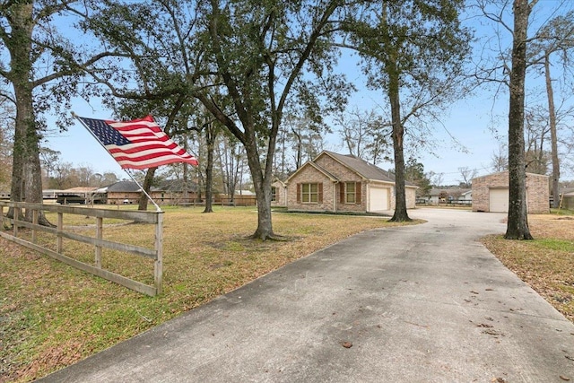 view of front of home featuring a garage and a front lawn