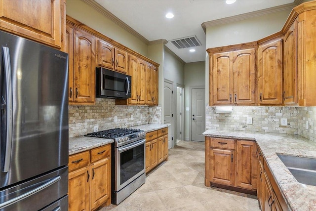 kitchen featuring tasteful backsplash, ornamental molding, stainless steel appliances, and light stone countertops