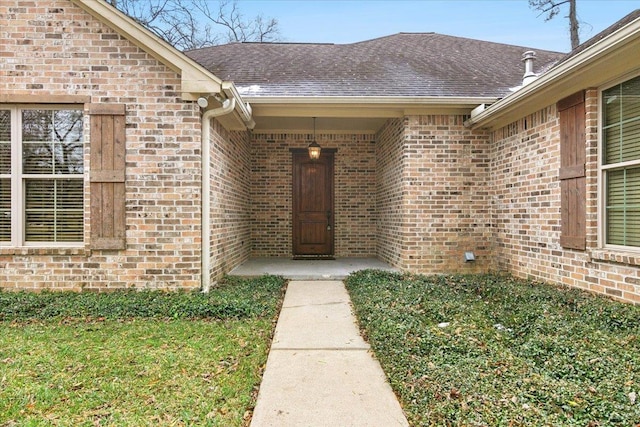 doorway to property featuring a yard