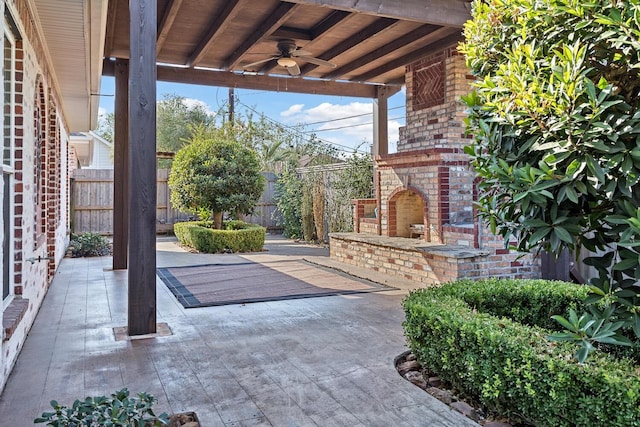 view of patio with ceiling fan and an outdoor brick fireplace