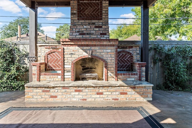 view of patio / terrace featuring an outdoor brick fireplace