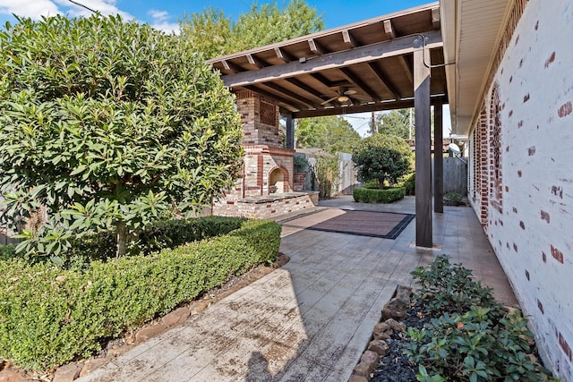 view of patio / terrace with an outdoor brick fireplace and ceiling fan