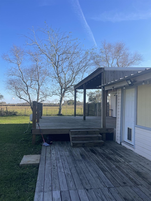 wooden deck with a lawn and fence