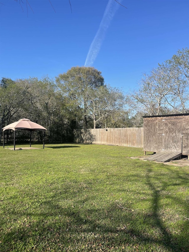 view of yard featuring fence and a gazebo