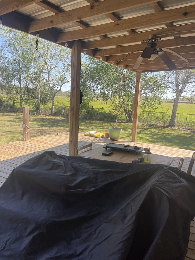 view of swimming pool featuring ceiling fan, fence, a deck, and a lawn