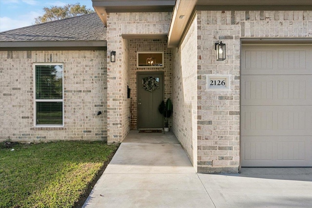 view of exterior entry with a garage