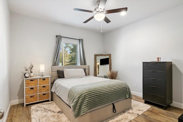 bedroom featuring ceiling fan and light hardwood / wood-style flooring