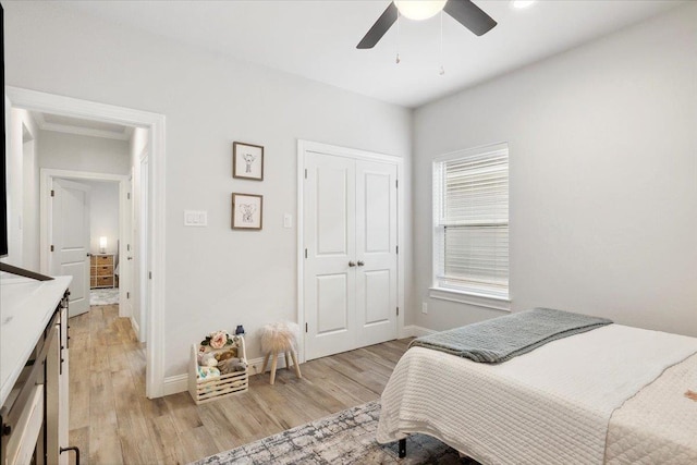 bedroom with a closet, ceiling fan, and light hardwood / wood-style floors