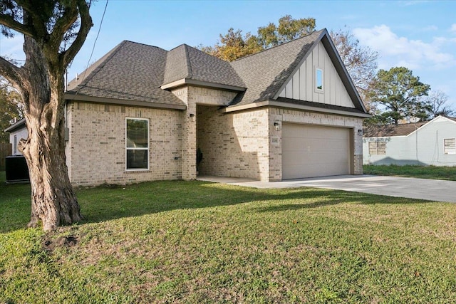 view of front of house featuring a front yard, a garage, and central AC unit