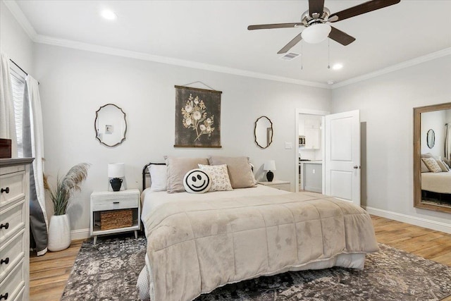 bedroom featuring ceiling fan, light hardwood / wood-style floors, and ornamental molding