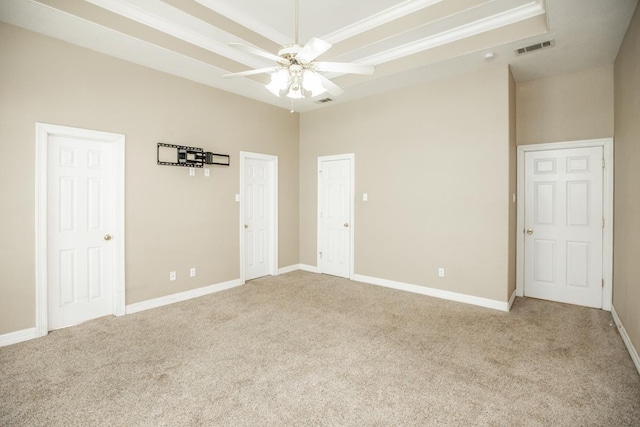 carpeted spare room with ceiling fan and a high ceiling