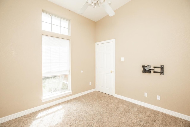 spare room featuring carpet, plenty of natural light, and ceiling fan