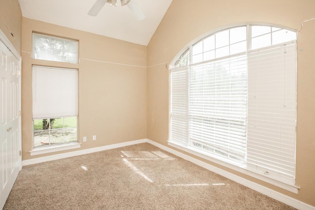 empty room featuring carpet floors, a wealth of natural light, lofted ceiling, and ceiling fan