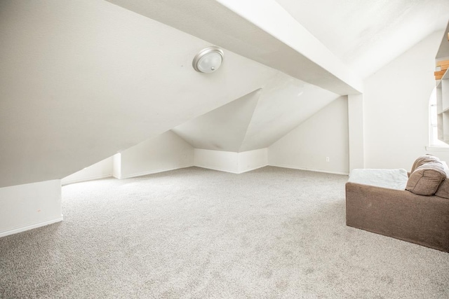 bonus room with carpet flooring and lofted ceiling