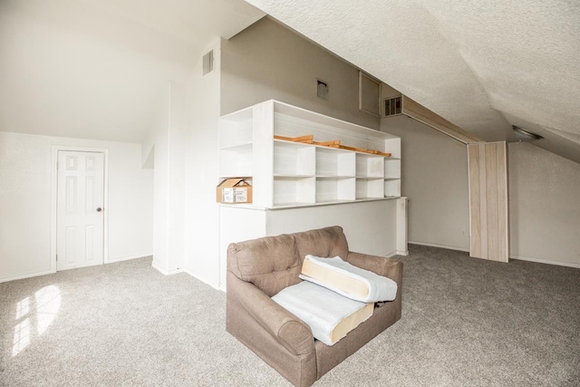 unfurnished room with a textured ceiling, light carpet, and lofted ceiling