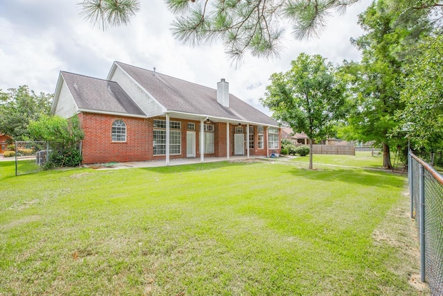 back of property featuring a yard and a patio