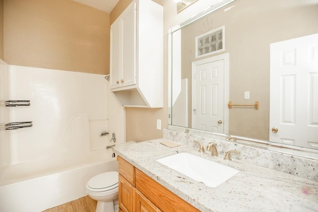 full bathroom with hardwood / wood-style flooring, vanity, toilet, and bathtub / shower combination