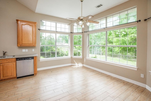 kitchen featuring ceiling fan, sink, light hardwood / wood-style flooring, dishwasher, and lofted ceiling