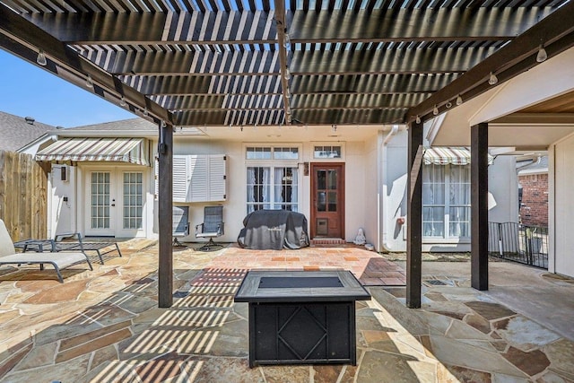 view of patio featuring fence, a pergola, a fire pit, and french doors