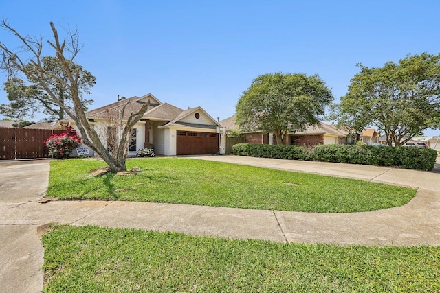 single story home with fence, an attached garage, a front yard, and concrete driveway