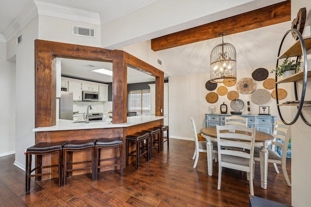 dining room featuring dark wood-style flooring, beamed ceiling, baseboards, a notable chandelier, and visible vents