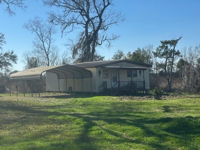 view of outbuilding featuring a yard, a carport, and a porch