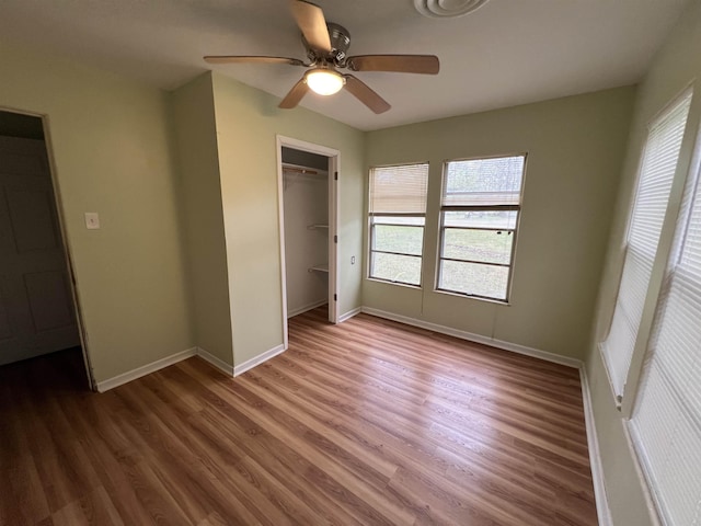 unfurnished bedroom featuring a closet, baseboards, and wood finished floors