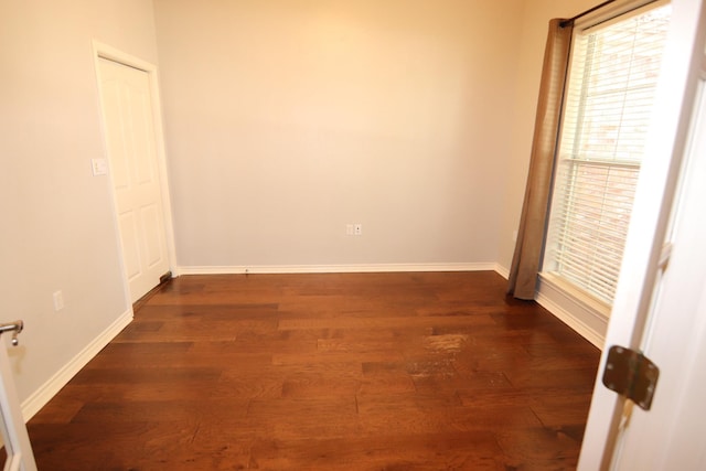 empty room with dark wood-type flooring