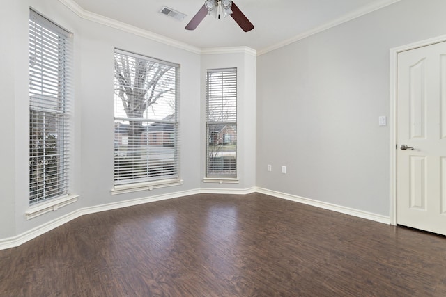 empty room featuring dark hardwood / wood-style flooring, crown molding, and ceiling fan