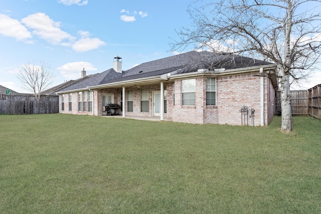 back of property featuring a lawn