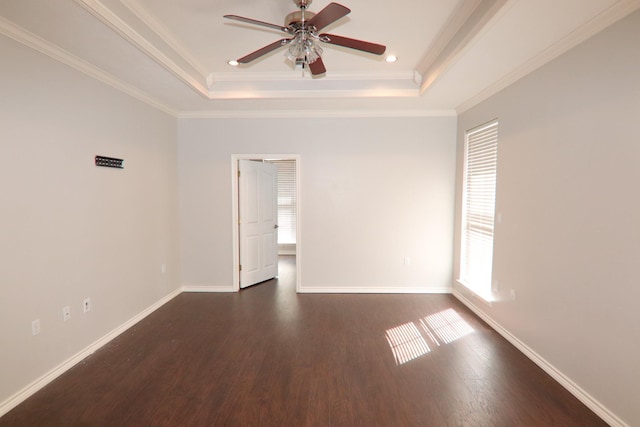 unfurnished room with a raised ceiling, ceiling fan, and ornamental molding