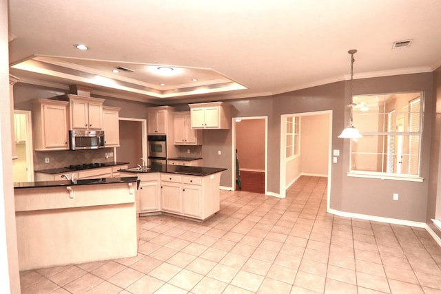 kitchen featuring crown molding, light tile patterned floors, appliances with stainless steel finishes, a tray ceiling, and decorative light fixtures