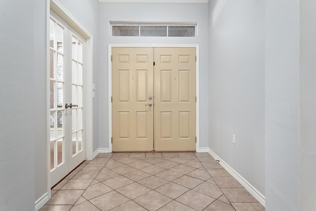 foyer entrance with light tile patterned flooring