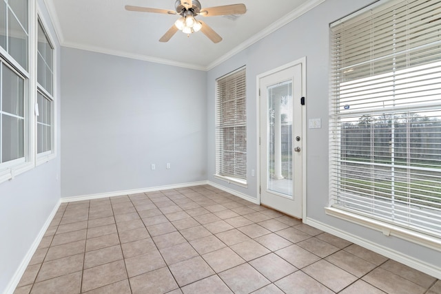 empty room with crown molding, ceiling fan, and a healthy amount of sunlight