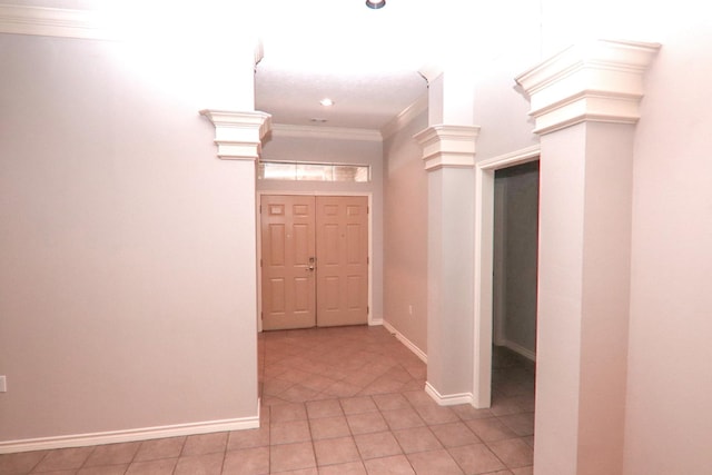 entrance foyer with light tile patterned flooring and ornamental molding