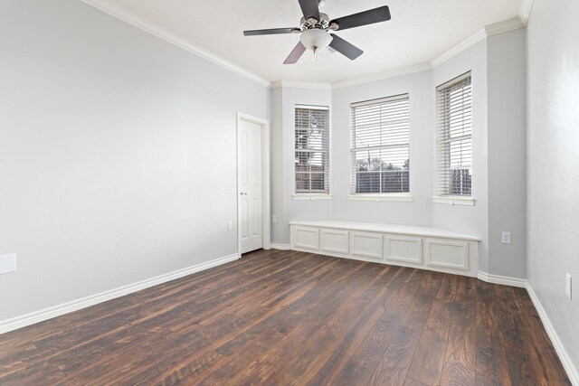 spare room with crown molding, ceiling fan, and dark hardwood / wood-style floors