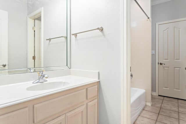 bathroom featuring shower / bathtub combination, vanity, and tile patterned flooring