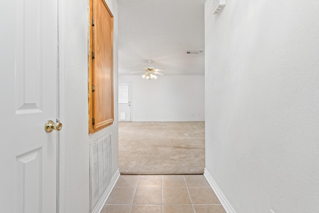 hall with light colored carpet