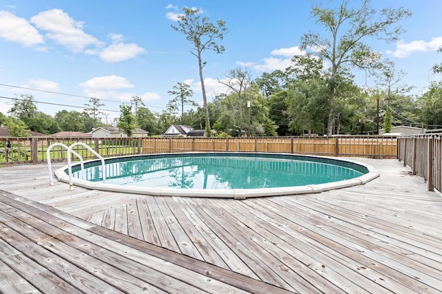 view of swimming pool with a deck