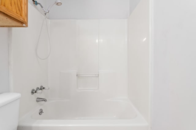 bathroom with shower / tub combination and toilet